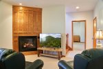 The downstairs sitting room has a TV and fireplace for your enjoyment.